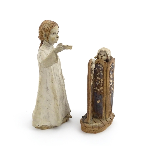 122 - Two studio pottery figurines by Graham Piggott of Blandon Pottery, one modelled as a child in a nigh... 