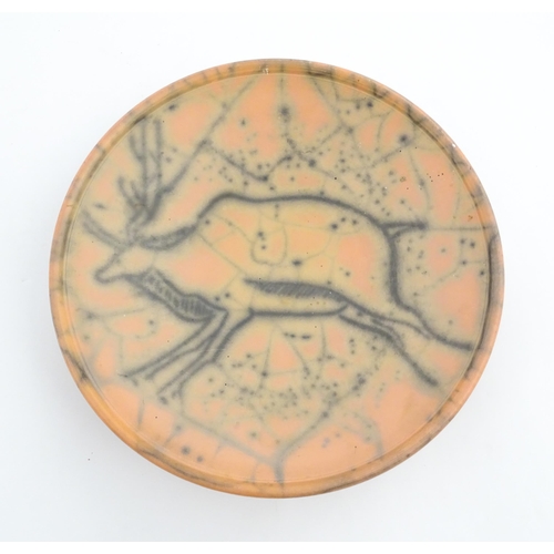 124 - A studio pottery charger with stylised African Eland / Antelope detail. Numbered under 26 03216. App... 