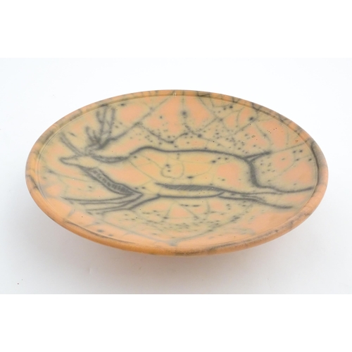 124 - A studio pottery charger with stylised African Eland / Antelope detail. Numbered under 26 03216. App... 