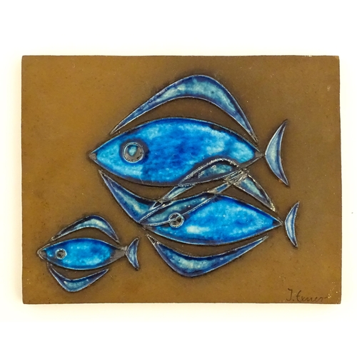 127 - A Danish studio pottery plaque / tile by Inge Exner for Knabstrup, Denmark, decorated with three fis... 