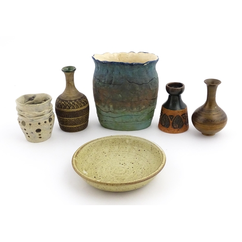 130 - A quantity of assorted studio pottery ceramics to include a candle holder with pierced detail by Cat... 