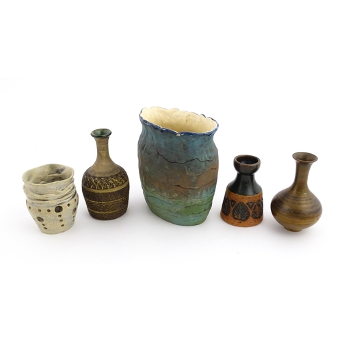 130 - A quantity of assorted studio pottery ceramics to include a candle holder with pierced detail by Cat... 