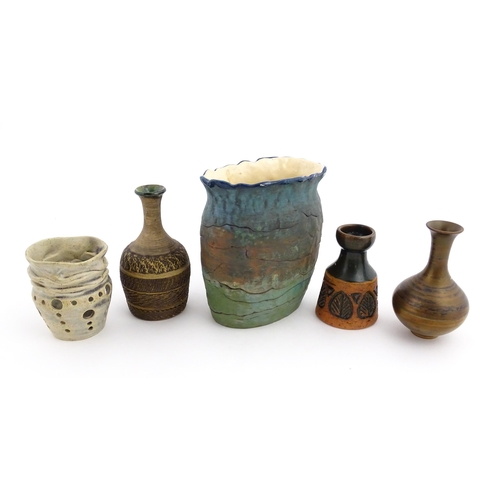 130 - A quantity of assorted studio pottery ceramics to include a candle holder with pierced detail by Cat... 