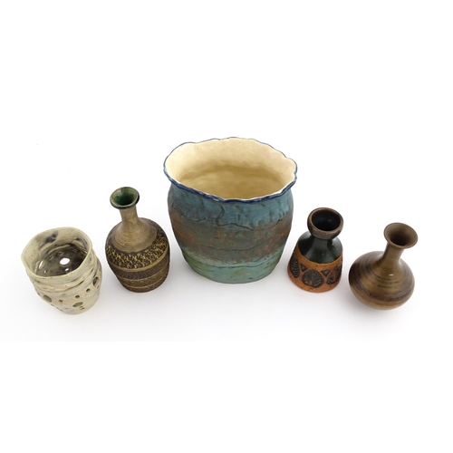 130 - A quantity of assorted studio pottery ceramics to include a candle holder with pierced detail by Cat... 