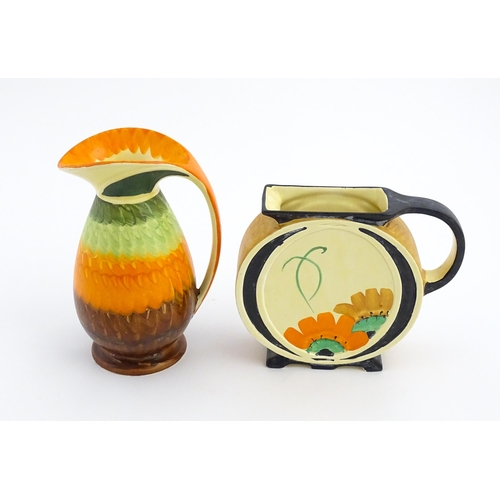 141 - A Myott Art Deco jug of circular form decorated with hand painted flowers. Together with another of ... 