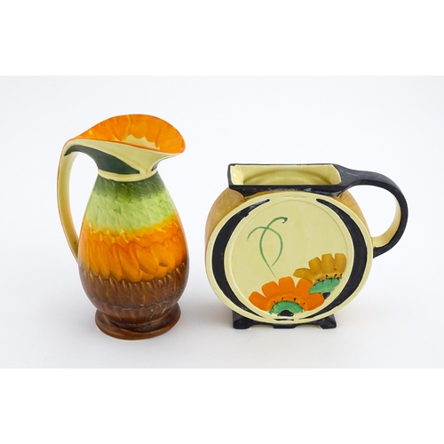 141 - A Myott Art Deco jug of circular form decorated with hand painted flowers. Together with another of ... 