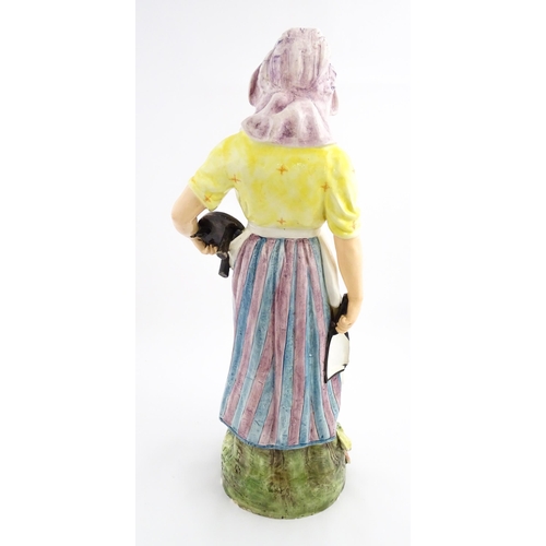 143 - A large Continental model of a milk maid with stool. Impressed under 11058. Approx. 37 1/2