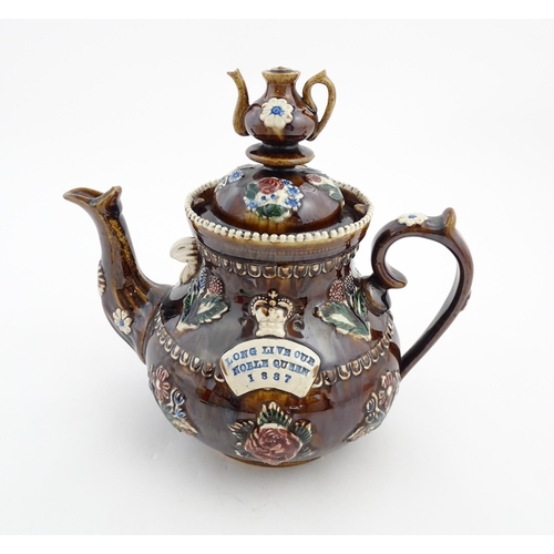 149 - A Victorian Measham bargeware teapot with a teapot finial to lid, decorated with flowers, foliage, r... 