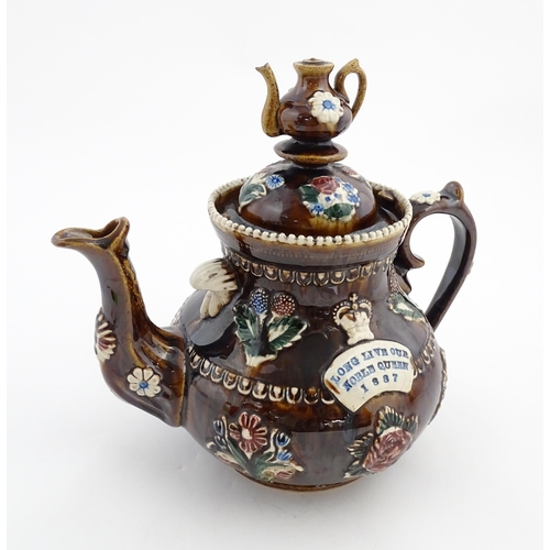 149 - A Victorian Measham bargeware teapot with a teapot finial to lid, decorated with flowers, foliage, r... 