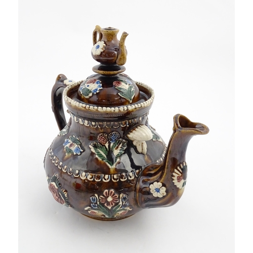 149 - A Victorian Measham bargeware teapot with a teapot finial to lid, decorated with flowers, foliage, r... 