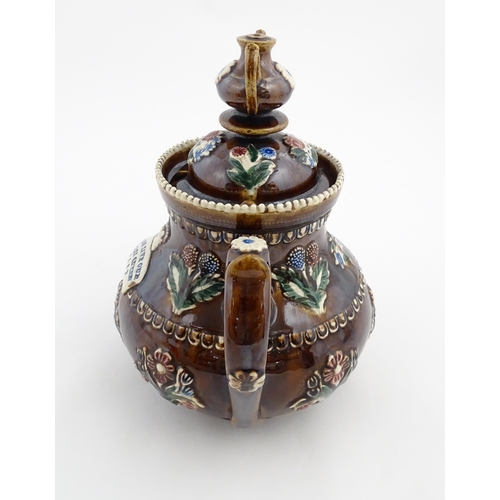 149 - A Victorian Measham bargeware teapot with a teapot finial to lid, decorated with flowers, foliage, r... 