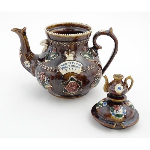 149 - A Victorian Measham bargeware teapot with a teapot finial to lid, decorated with flowers, foliage, r... 