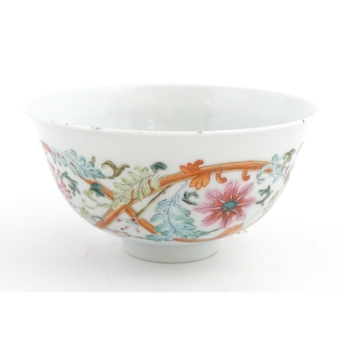 15 - A Chinese famille rose bowl decorated with flowers and foliage. The interior with five bat motifs. C... 