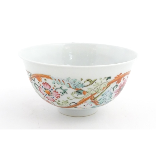 15 - A Chinese famille rose bowl decorated with flowers and foliage. The interior with five bat motifs. C... 