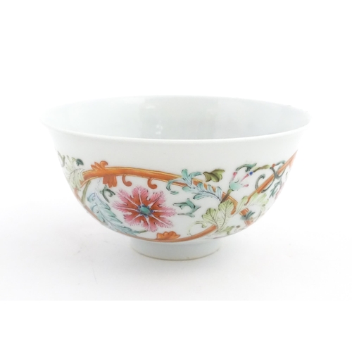 15 - A Chinese famille rose bowl decorated with flowers and foliage. The interior with five bat motifs. C... 