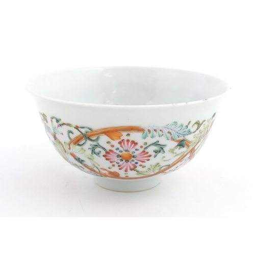 15 - A Chinese famille rose bowl decorated with flowers and foliage. The interior with five bat motifs. C... 