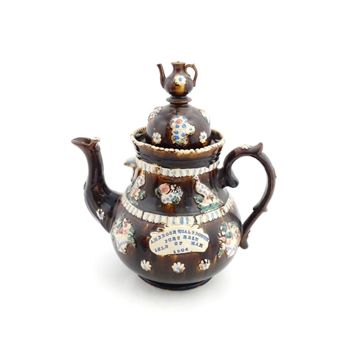 154 - A large Measham bargeware teapot with teapot finial to lid, decorated with baskets of flowers, birds... 