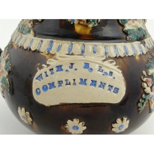 154 - A large Measham bargeware teapot with teapot finial to lid, decorated with baskets of flowers, birds... 