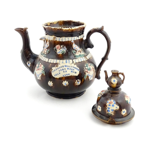 154 - A large Measham bargeware teapot with teapot finial to lid, decorated with baskets of flowers, birds... 