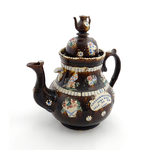 154 - A large Measham bargeware teapot with teapot finial to lid, decorated with baskets of flowers, birds... 