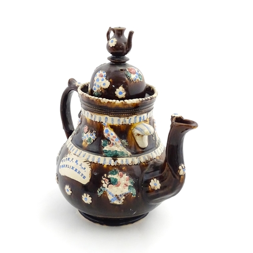 154 - A large Measham bargeware teapot with teapot finial to lid, decorated with baskets of flowers, birds... 