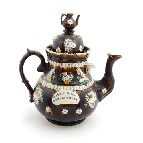 154 - A large Measham bargeware teapot with teapot finial to lid, decorated with baskets of flowers, birds... 