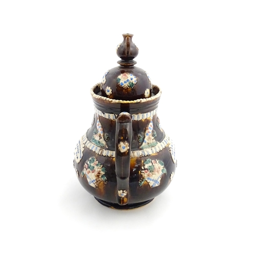 154 - A large Measham bargeware teapot with teapot finial to lid, decorated with baskets of flowers, birds... 