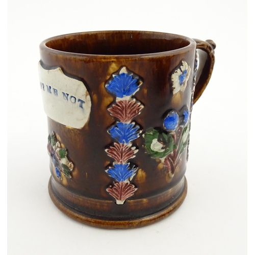 155 - A Victorian Measham bargeware large mug with flower detail and plaque titled Forget Me Not. Approx. ... 