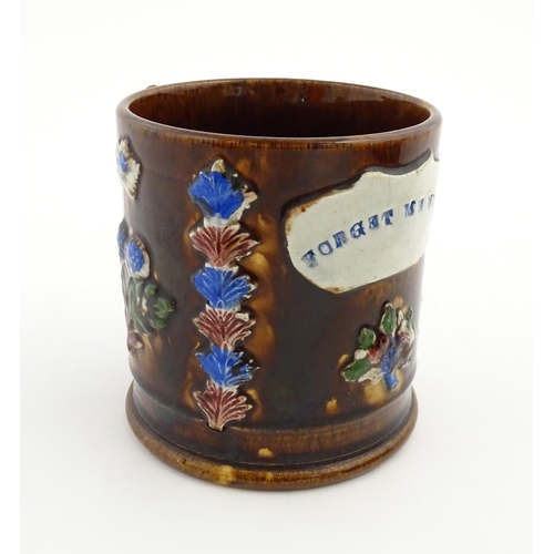 155 - A Victorian Measham bargeware large mug with flower detail and plaque titled Forget Me Not. Approx. ... 