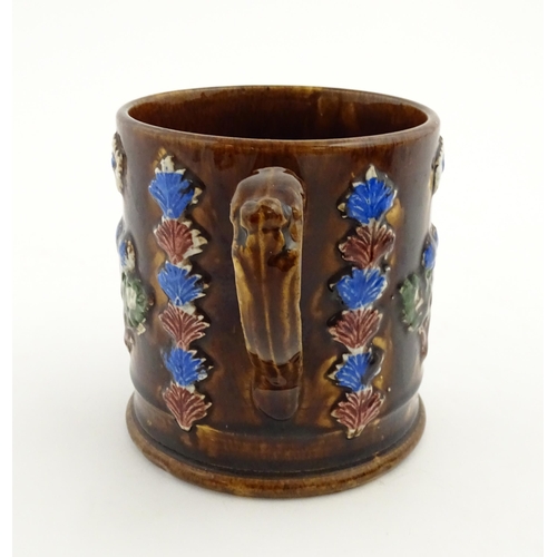 155 - A Victorian Measham bargeware large mug with flower detail and plaque titled Forget Me Not. Approx. ... 