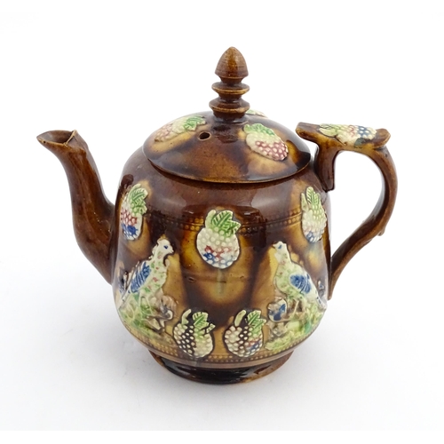 156 - A Victorian Measham bargeware teapot decorated with birds and berries. Approx. 7 3/4