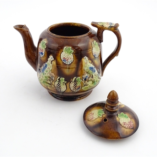 156 - A Victorian Measham bargeware teapot decorated with birds and berries. Approx. 7 3/4