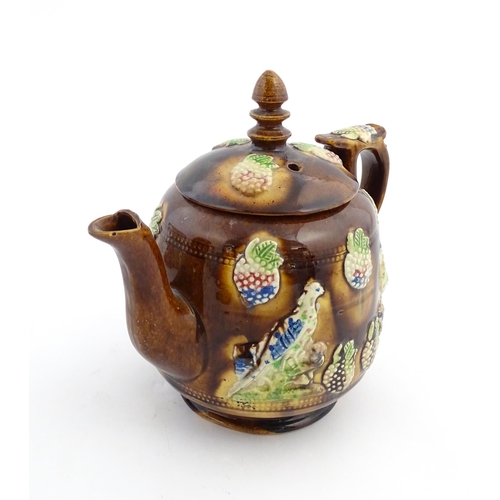 156 - A Victorian Measham bargeware teapot decorated with birds and berries. Approx. 7 3/4