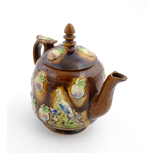 156 - A Victorian Measham bargeware teapot decorated with birds and berries. Approx. 7 3/4