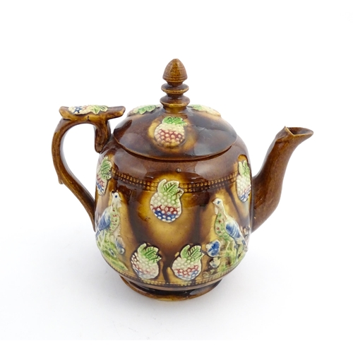 156 - A Victorian Measham bargeware teapot decorated with birds and berries. Approx. 7 3/4