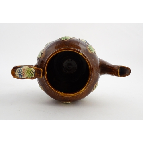 156 - A Victorian Measham bargeware teapot decorated with birds and berries. Approx. 7 3/4