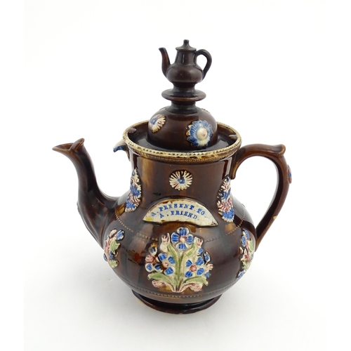 162 - A Victorian Measham bargeware teapot with teapot finial to lid, decorated with flowers and foliage, ... 