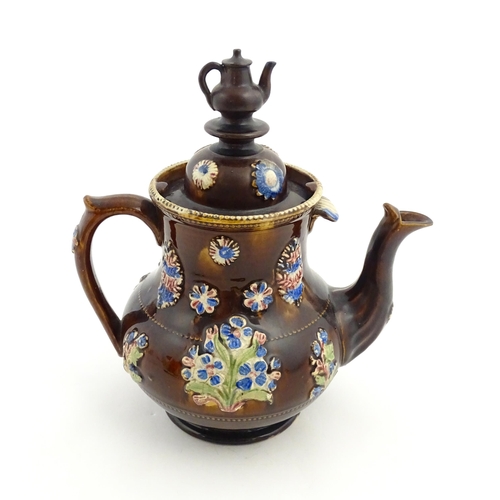 162 - A Victorian Measham bargeware teapot with teapot finial to lid, decorated with flowers and foliage, ... 