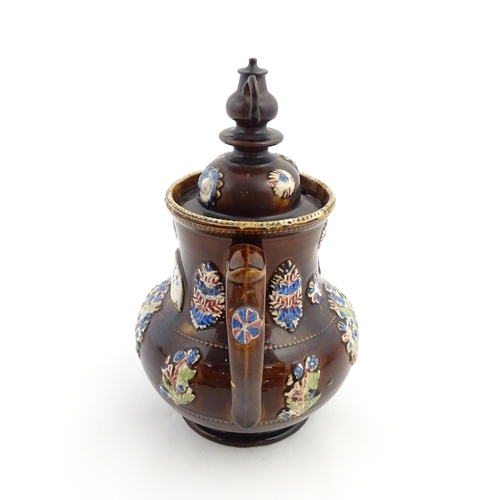 162 - A Victorian Measham bargeware teapot with teapot finial to lid, decorated with flowers and foliage, ... 