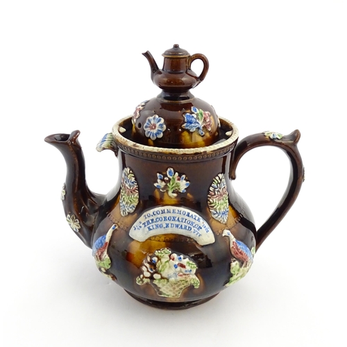 165 - A Measham bargeware commemorative teapot with teapot finial to lid, decorated with birds, flowers, f... 