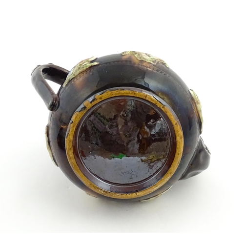 165 - A Measham bargeware commemorative teapot with teapot finial to lid, decorated with birds, flowers, f... 