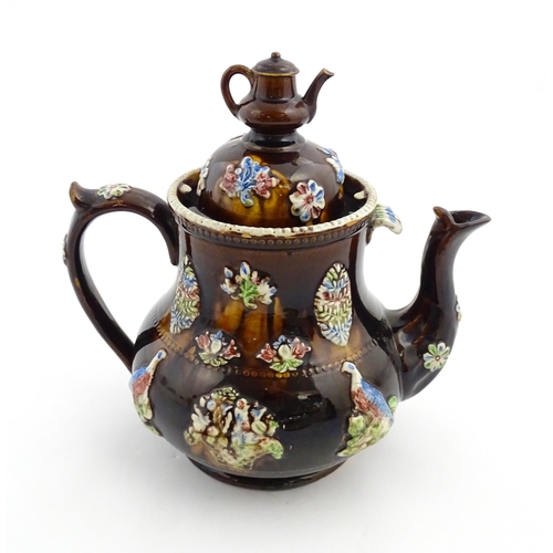 165 - A Measham bargeware commemorative teapot with teapot finial to lid, decorated with birds, flowers, f... 