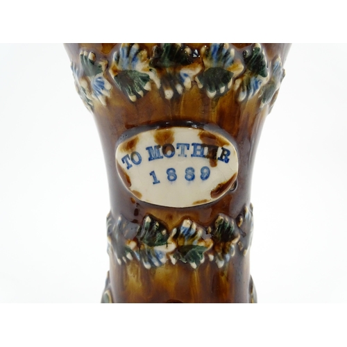 166 - A Victorian Measham bargeware vase of waisted form decorated with berries and bands of foliate detai... 