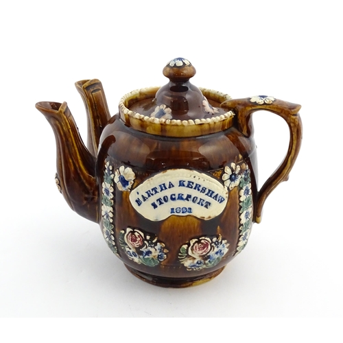 167 - A Victorian Measham bargeware double spout teapot decorated with flowers and foliage, bears plaque t... 