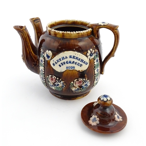 167 - A Victorian Measham bargeware double spout teapot decorated with flowers and foliage, bears plaque t... 