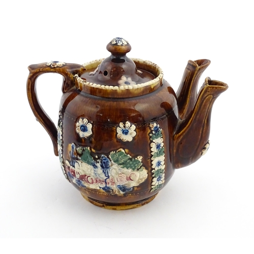 167 - A Victorian Measham bargeware double spout teapot decorated with flowers and foliage, bears plaque t... 