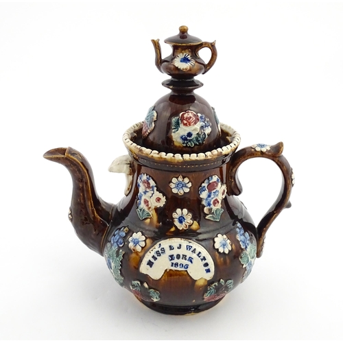 168 - A large Victorian Measham bargeware teapot with teapot finial to lid, decorated with flowers and fol... 