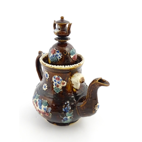 168 - A large Victorian Measham bargeware teapot with teapot finial to lid, decorated with flowers and fol... 