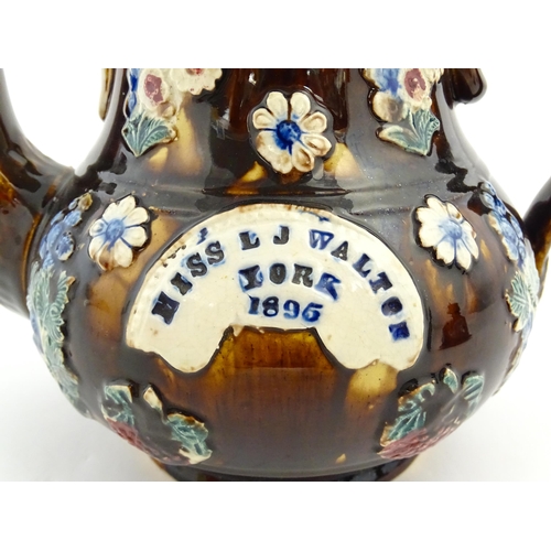 168 - A large Victorian Measham bargeware teapot with teapot finial to lid, decorated with flowers and fol... 