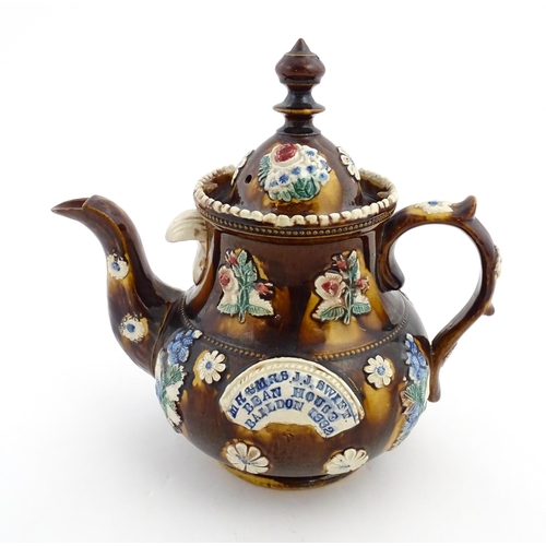 171 - A Victorian Measham bargeware teapot decorated with flowers and foliage, bearing plaque titled Mr & ... 